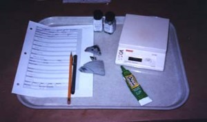toolkit Materials used in cataloging: catalog record forms, archival polyethylene bags, liquid lacquer for labels, and marking pens and pencils.