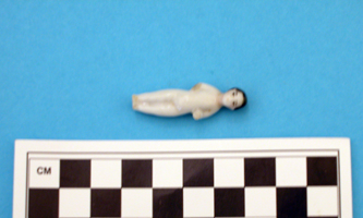 figurine Frozen Charlotte doll, less than 4 cm long.